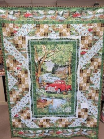 Quilt top picturing an old truck down by the lake.