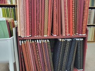 Two shelves of Kim Diehl fabrics